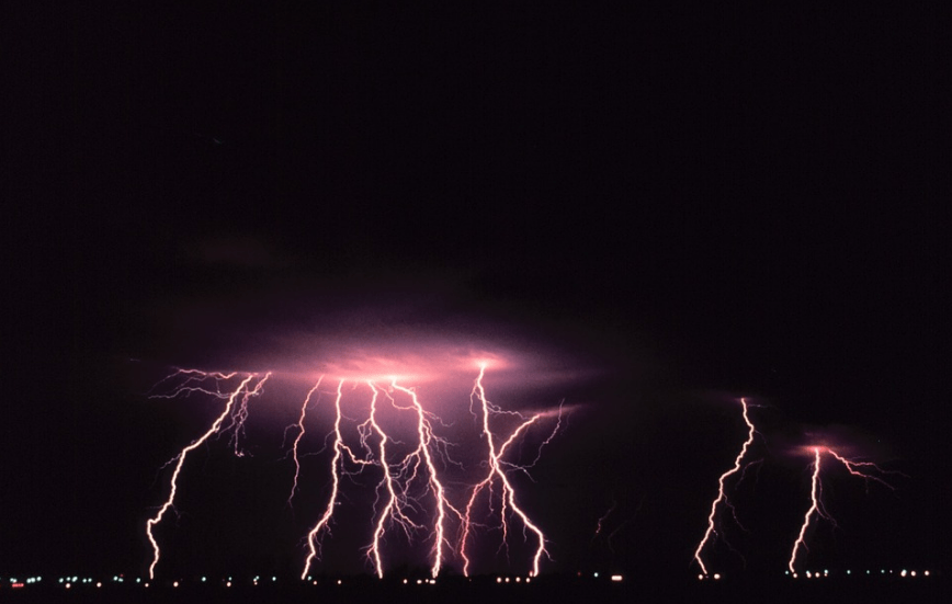 Storm clouds, lightning bolts, city lights