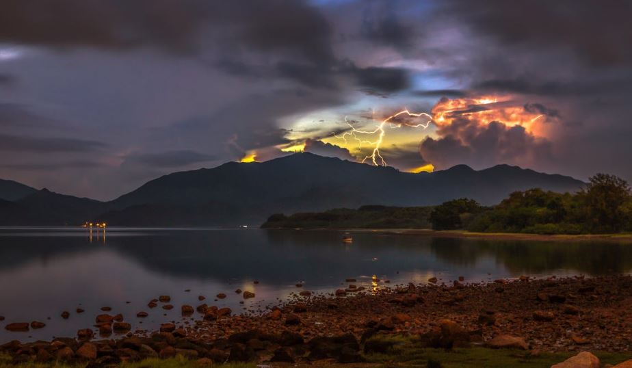 A lightning seen from a rocky shore