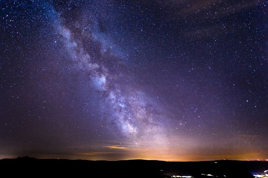 bright stars, dark blue skies, silhouette landscape