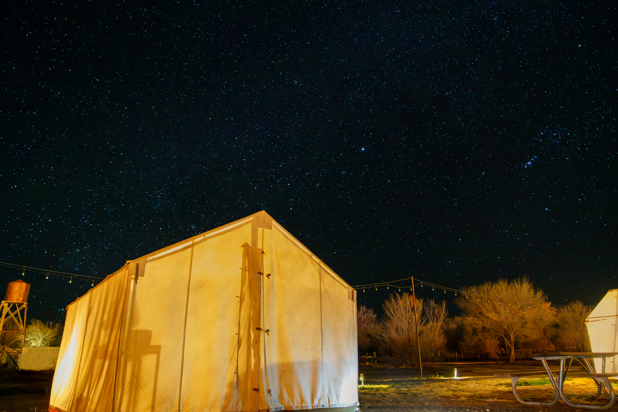 Canvas tent glamping under clear star filled night sky in Marfa, Texas