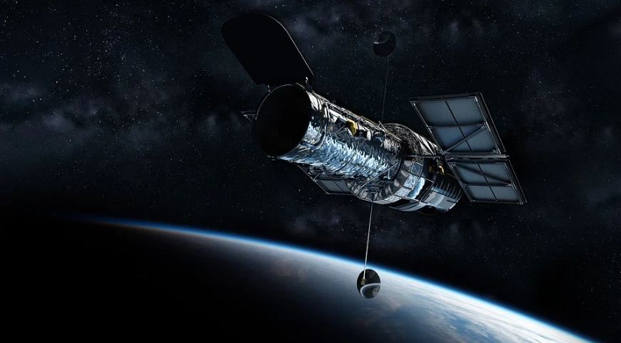 cylindrical object with wings, dark skies with bright dots