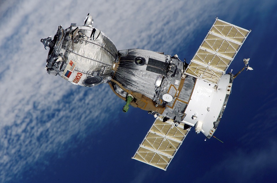 satellite floating, blue background with white foggy area