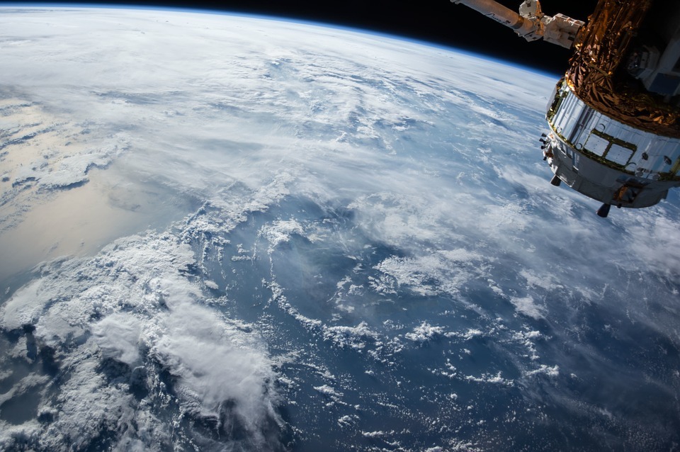 satellite on the upper right side, blue earth, white sheets on earth