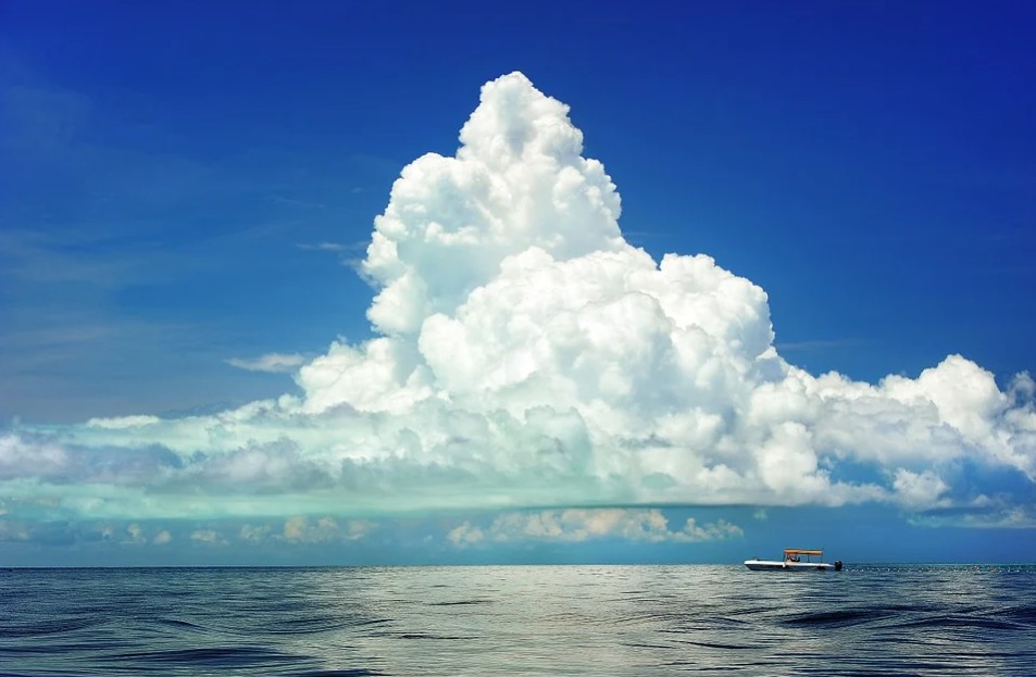 a mountain-shape cloud on the horizon