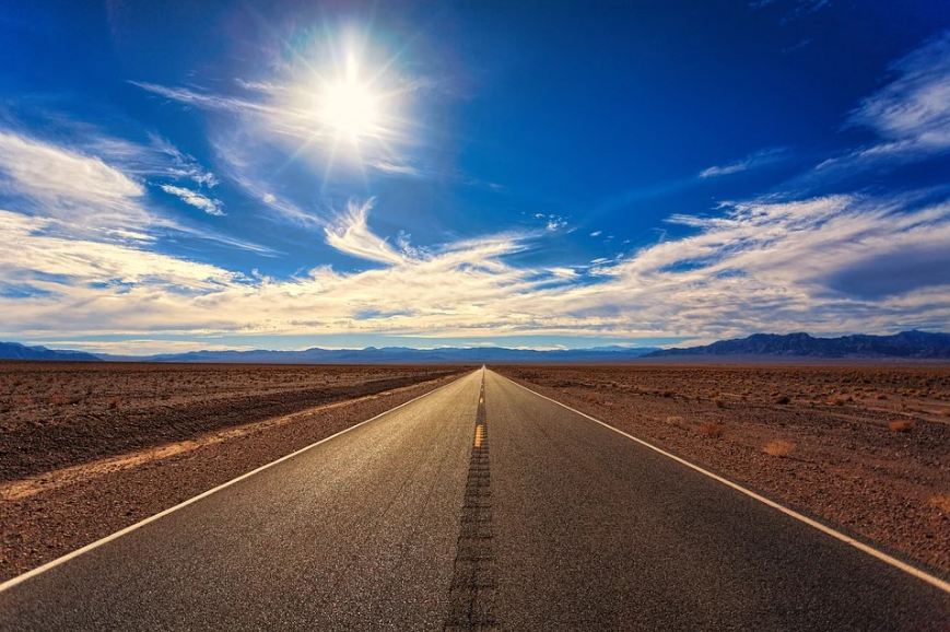 a road and the dry land, with the scorching heat of the sun