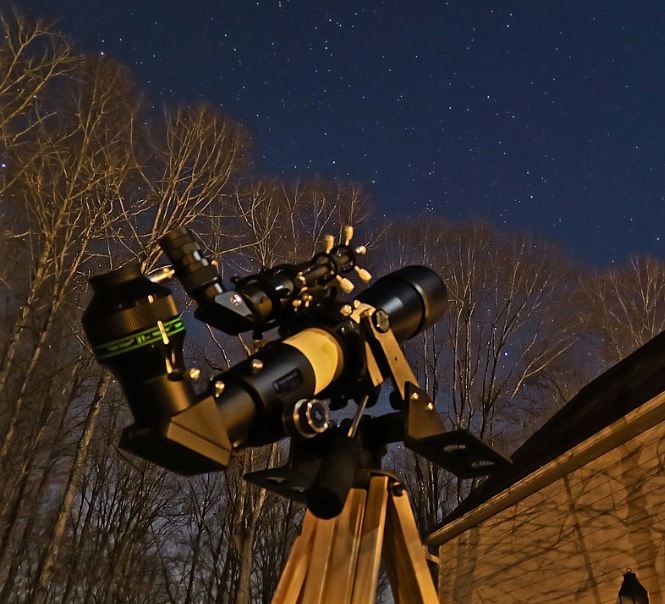 a telescope and a night sky with stars