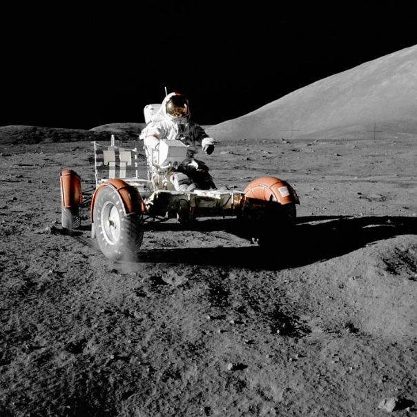astronaut riding a vehicle, gray and rough moon surface