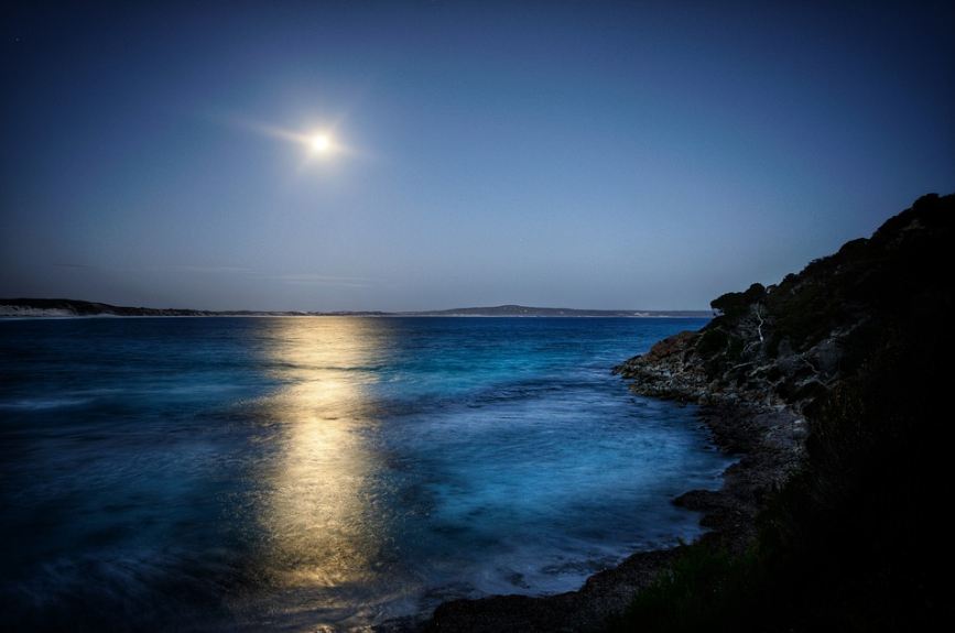 moonlight on the night sky reflected on the sea