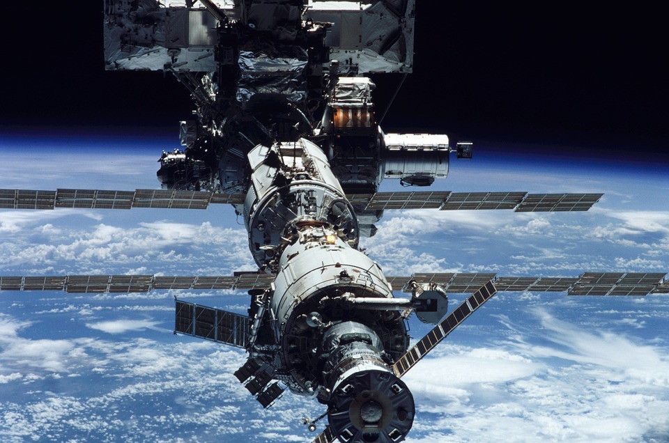 International Space Station orbiting the Earth, Earth’s atmosphere, white clouds, black space
