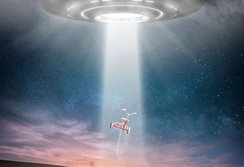 a wide field, a child looking into the clouds, and a bicycle floating in the air with a spaceship casting a light