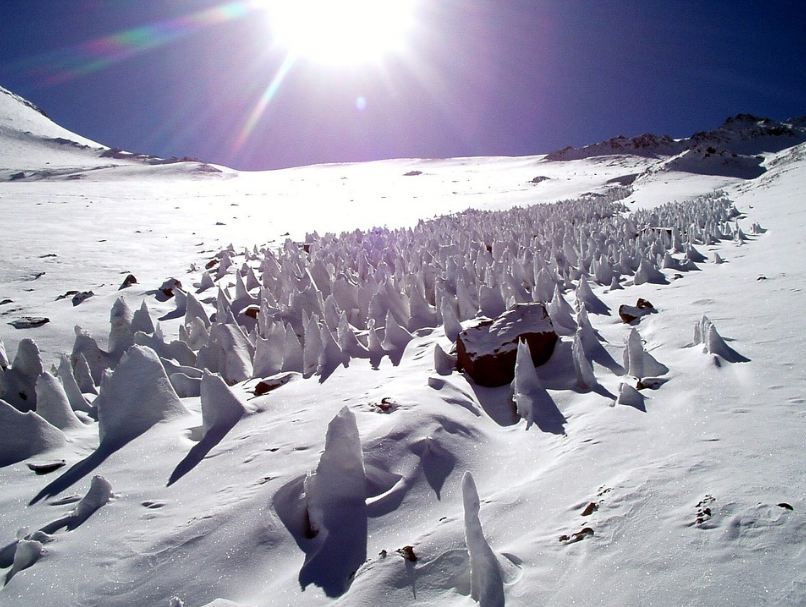 tall ice formations, snowy surface, snowy mountains