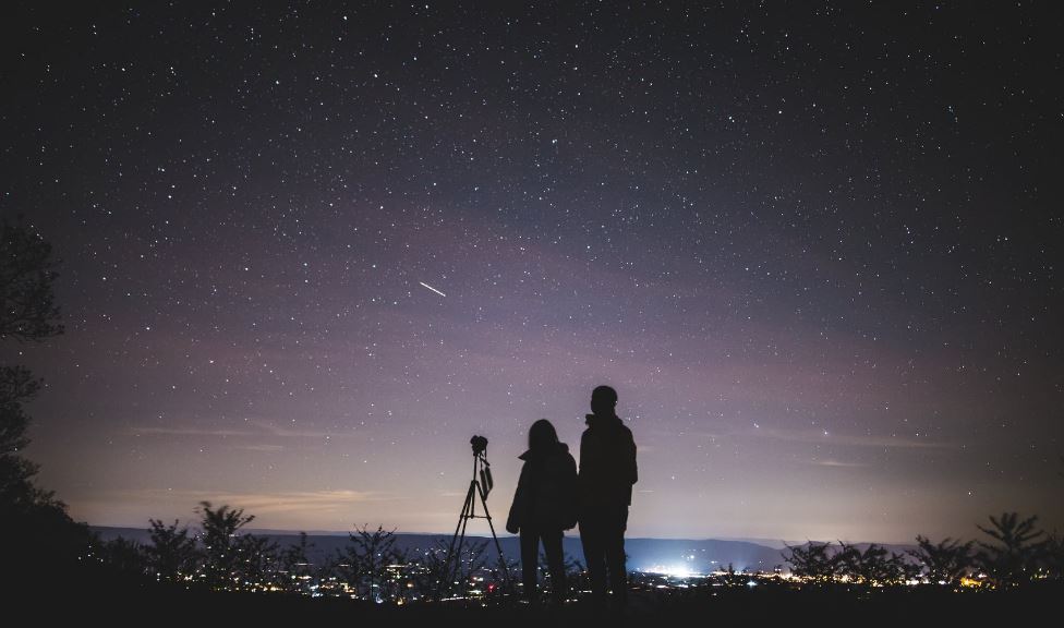 Two persons stargazing